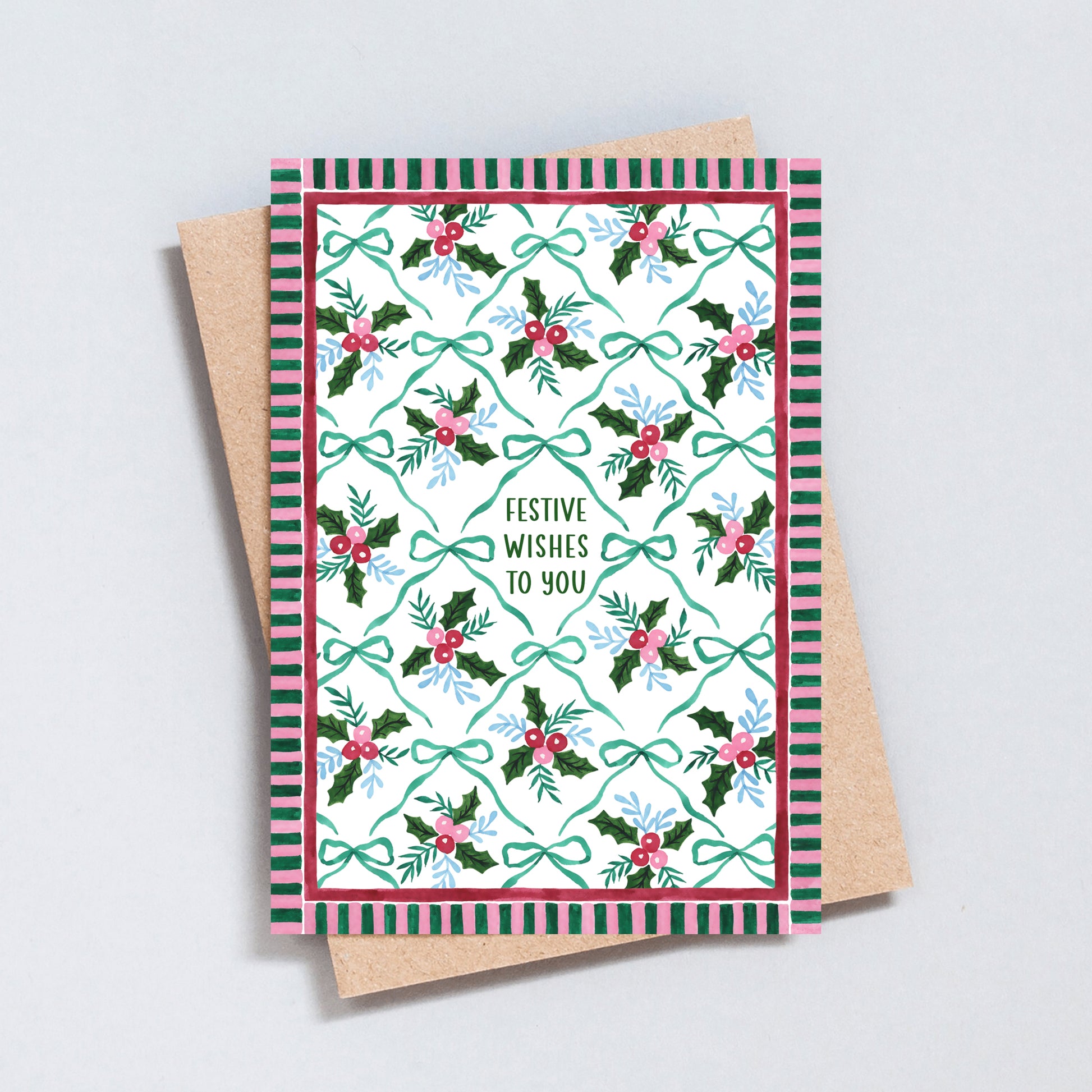 Festive Wishes to You Christmas card with hand-painted holly, berries and bows in green, red and blue, surrounded by a pink and green striped border.