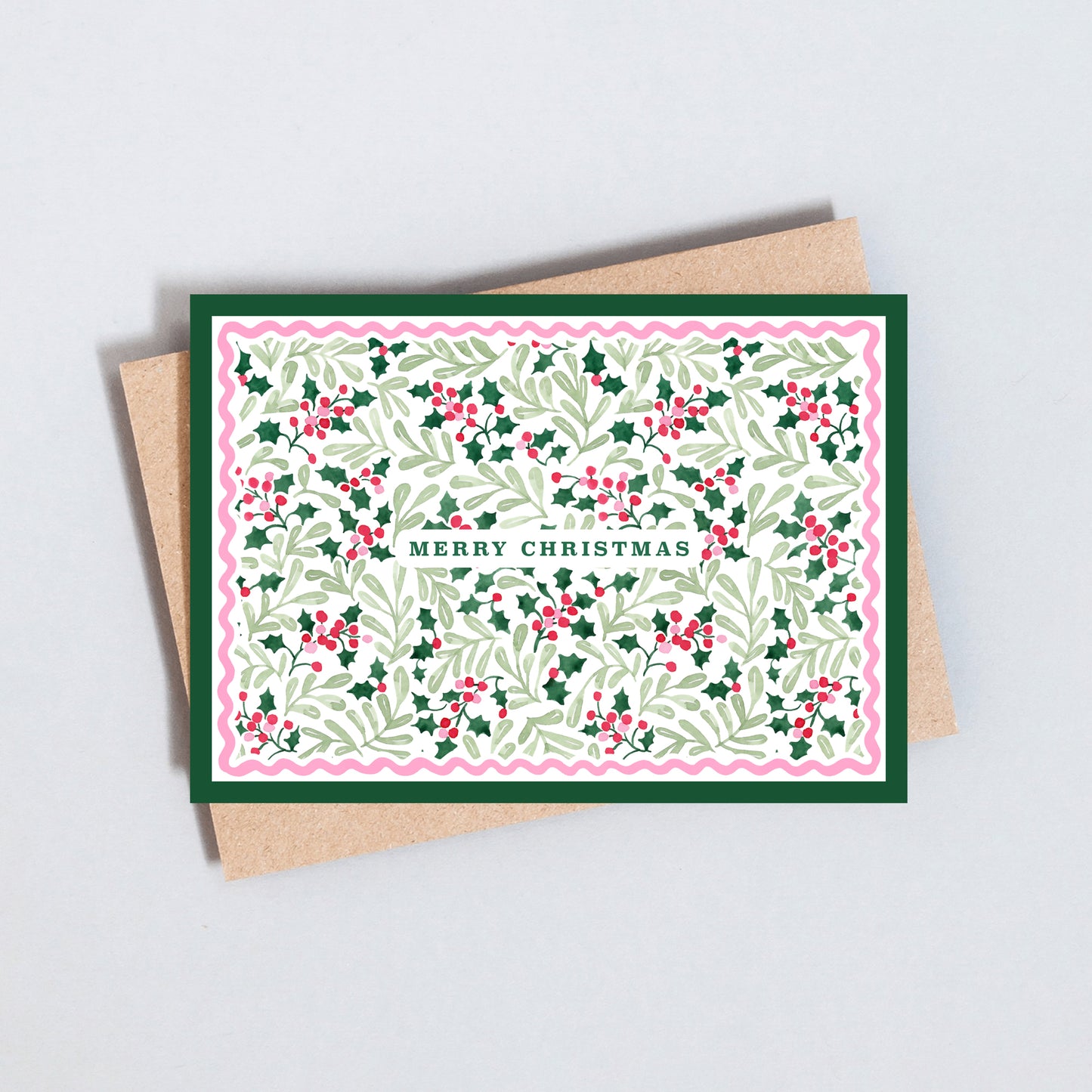 Traditional Merry Christmas card featuring an illustrated holly leaf and berry pattern with decorative scalloped border.