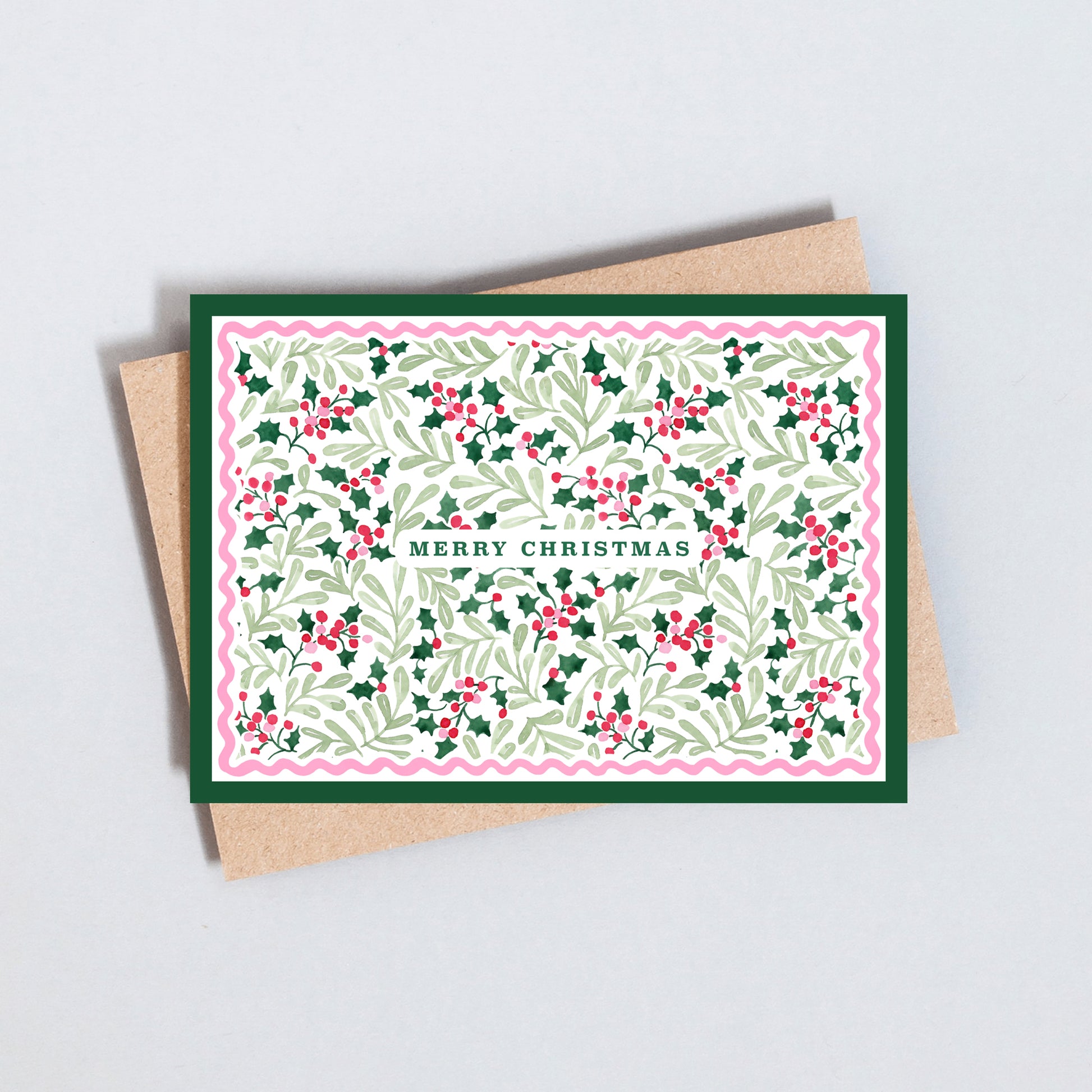 Traditional Merry Christmas card featuring an illustrated holly leaf and berry pattern with decorative scalloped border.