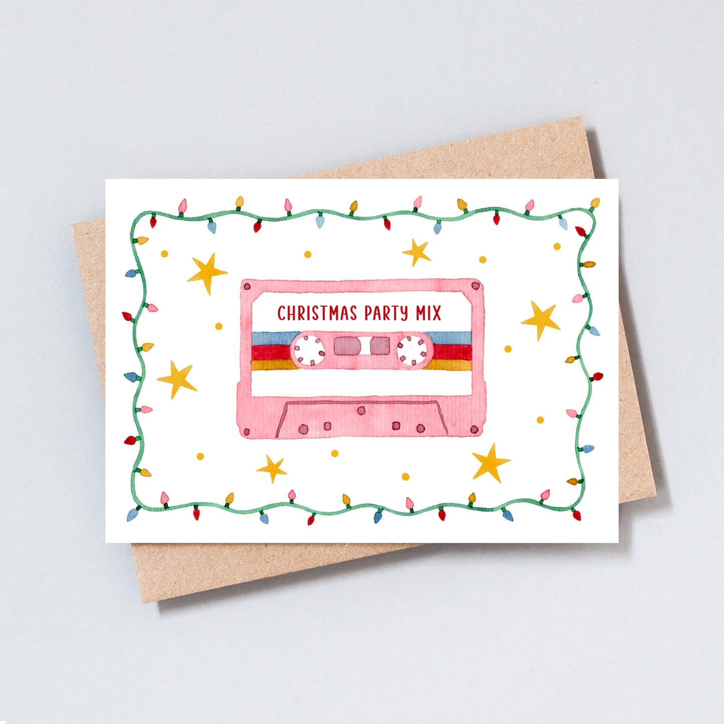 Retro Christmas card featuring a pink cassette tape labeled “Christmas Party Mix,” surrounded by holly and festive lights, illustrated by The Type Club.