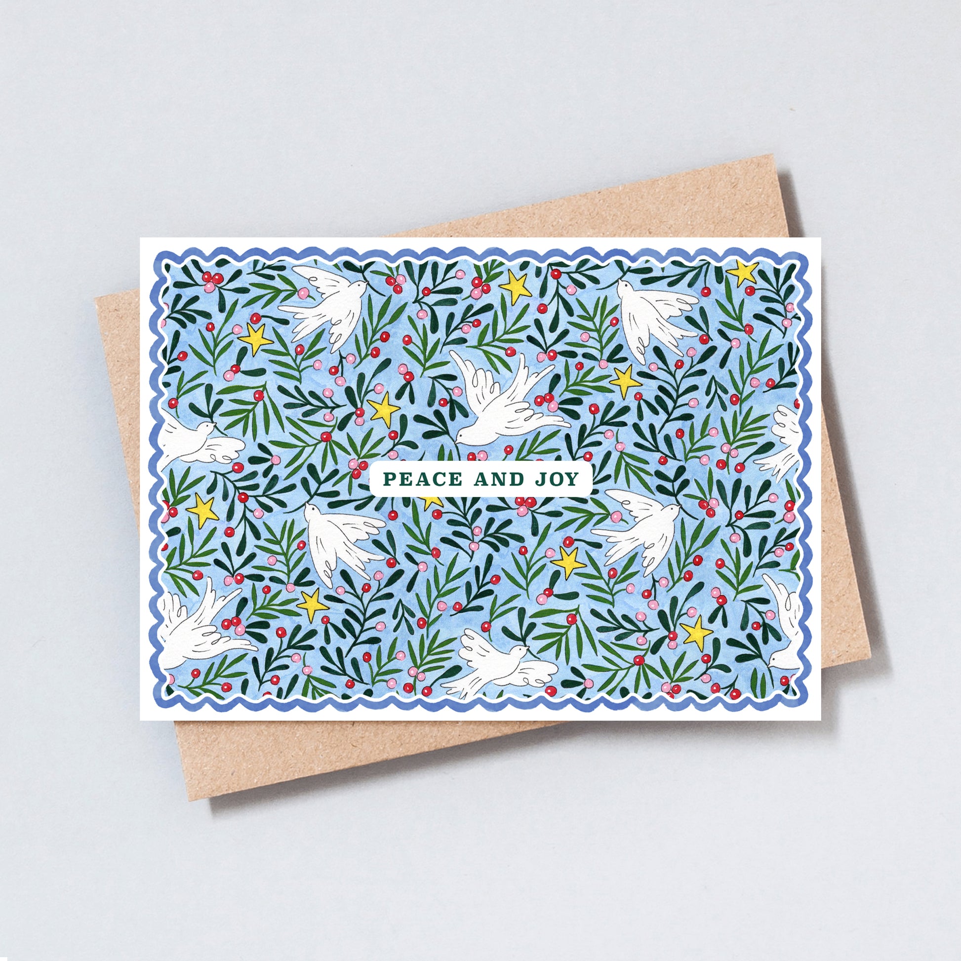 Illustrated Peace and Joy Christmas card featuring white doves, evergreen foliage, winter berries and golden stars on a soft blue background.