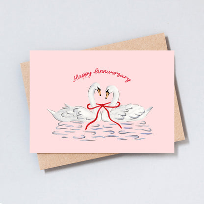 Romantic swan anniversary card with hand-drawn illustration on pink background