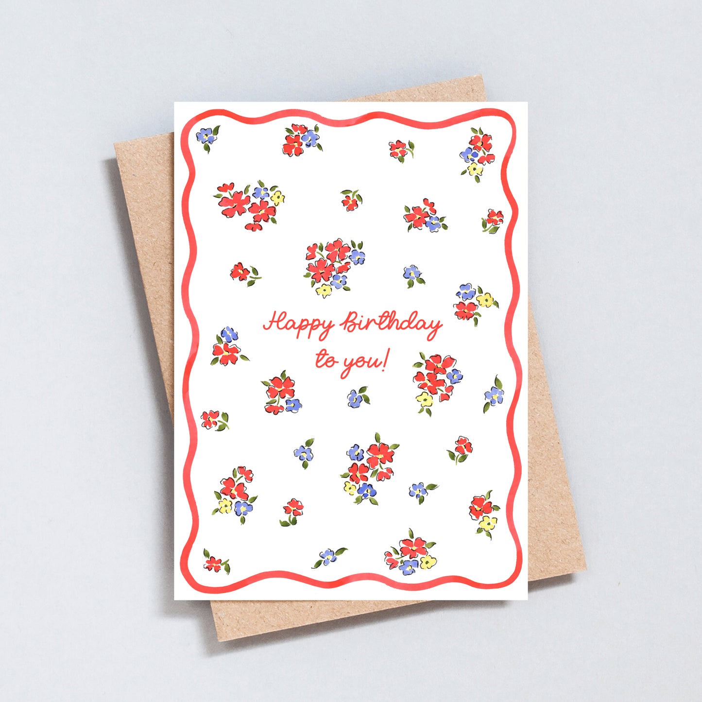 Minimal floral birthday card with scattered colourful flowers, pink script lettering and pink wavy border