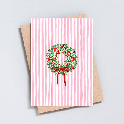 Pink striped Christmas card with hand-painted holly wreath and red bow, designed by The Type Club