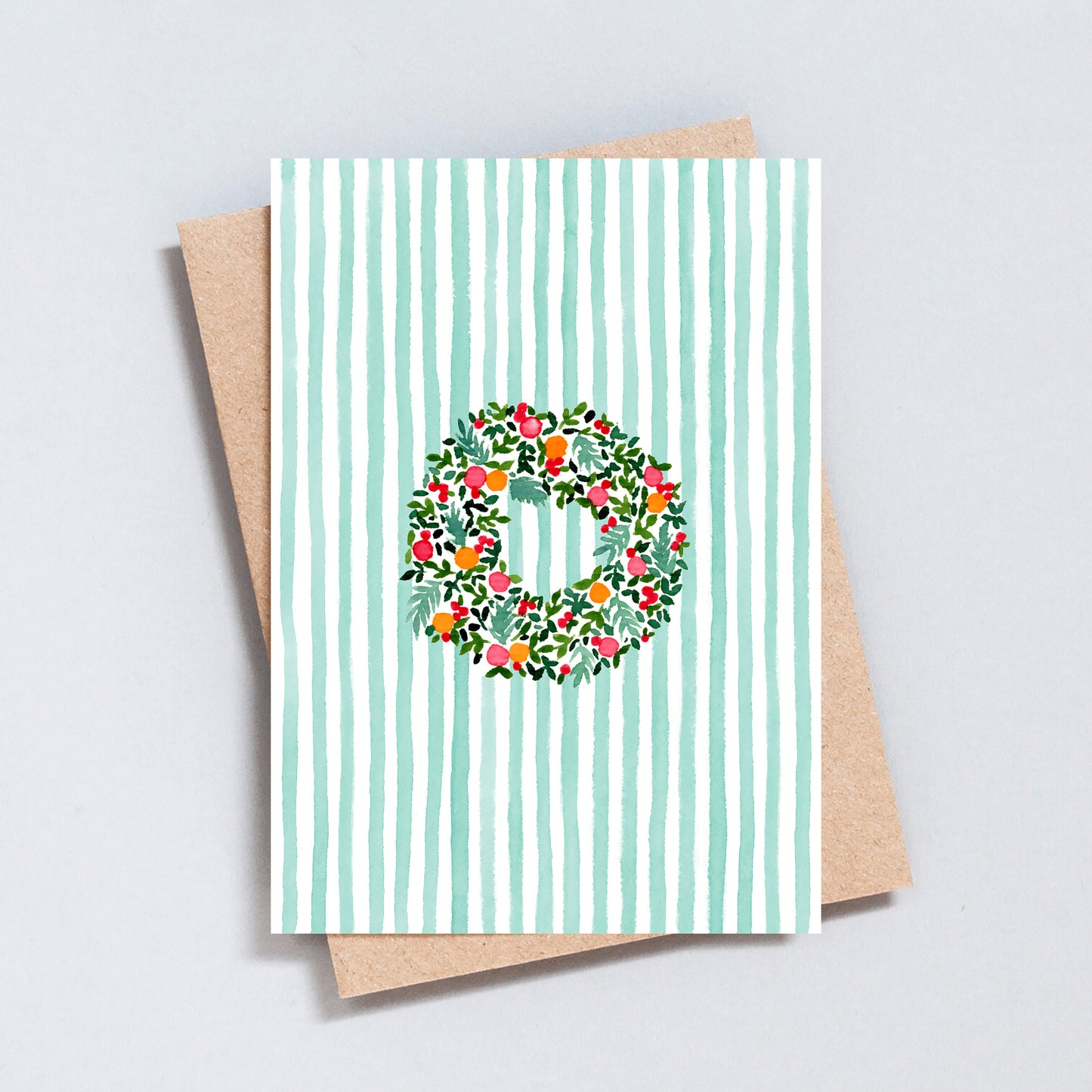Hand-painted Christmas wreath card with green stripes and kraft envelope by The Type Club.