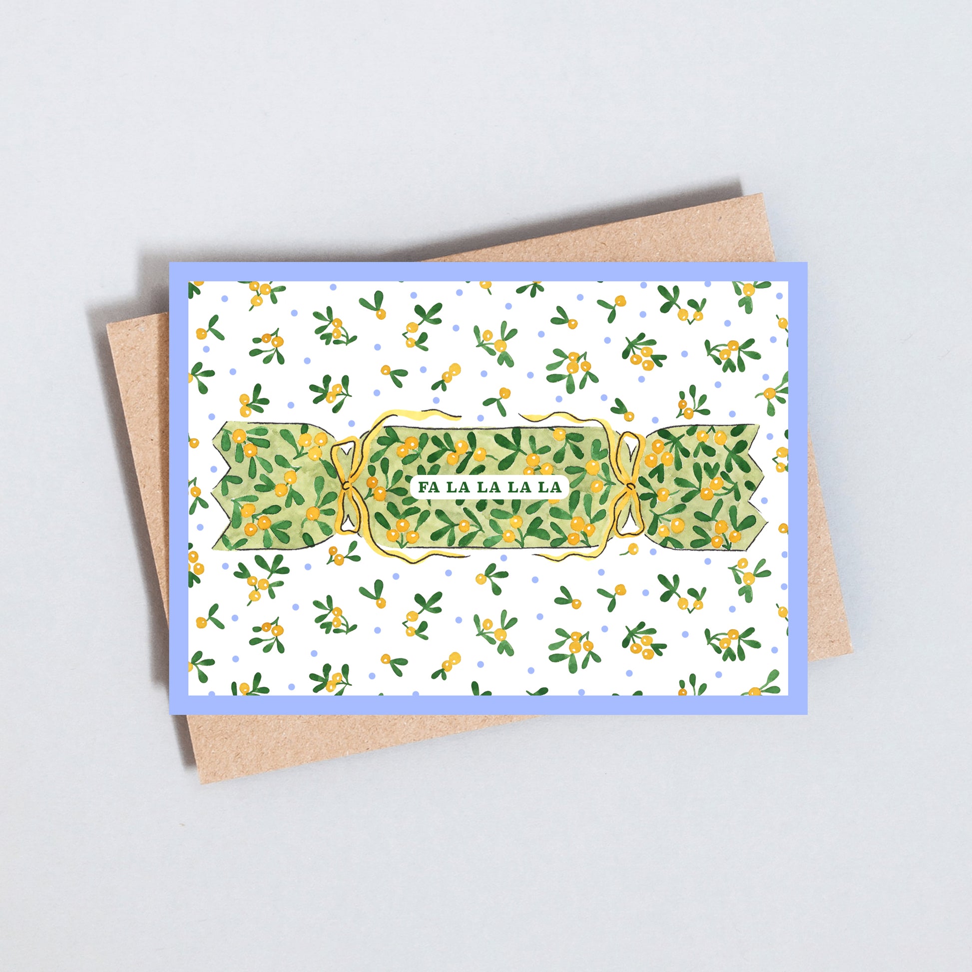 Illustrated Christmas card featuring a traditional Christmas cracker with festive greenery and Fa La La La greeting on textured white card.